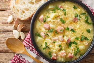 Cossack Ukrainian rich soup kulish made of millet, potatoes, onions with bacon close-up in a plate on the table. horizontal top view from above
