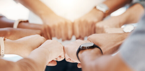 Group, circle and fist bump with team building closeup, community or collaboration for goals in...