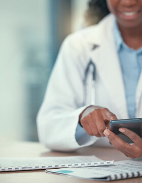 Phone, doctor and hands of black woman texting for telehealth, healthcare or research in hospital. Smartphone, medical professional or happy person with online consultation, reading email or wellness