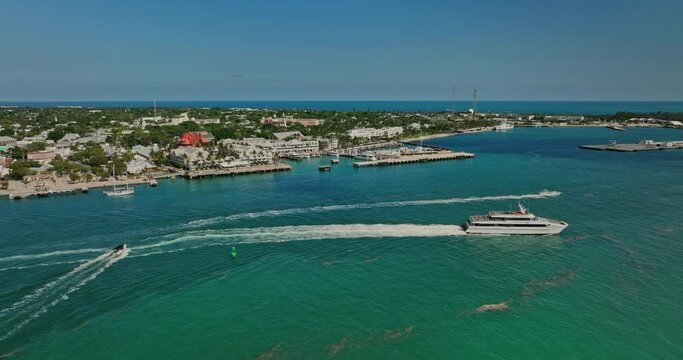 Key West Florida Aerial v11 flyover Mallory Square waterfront plaza along Front street capturing cruise ship sailing on channel and cityscape of historic old town - Shot with Mavic 3 Cine - April 2022