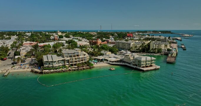 Key West Florida Aerial v17 cinematic low level drone flyover waterfront resorts and hotels capturing beaches, sunset pier and Mallory Square in summer - Shot with Mavic 3 Cine - April 2022