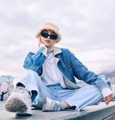 Portrait, fashion and Islamic woman in a city, sunglasses and trendy with a hijab, stylish outfit...