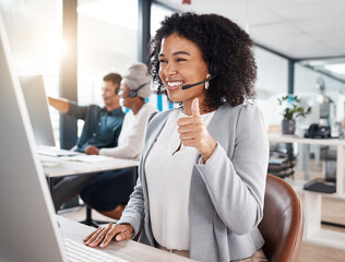 Call centre, woman and thumb up for online support with smile for success with headset, computer. Customer service, telemarketing and worker is happy with hand gesture for motivation and agreement.