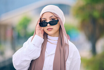 Portrait, fashion or sunglasses with an arabic woman outdoor in a cap and scarf for contemporary...