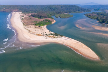 Aerial top view on tropical beach with green palm trees under sunlight Drone view in Goa - obrazy, fototapety, plakaty