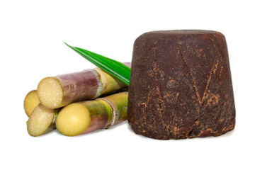 Organic Jaggery ( unrefined sugar ) and sugarcane isolated on white background.