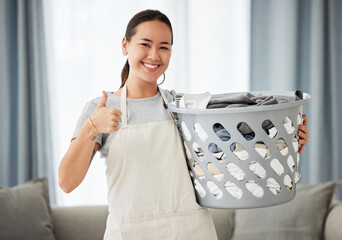 Happy asian woman, laundry and thumbs up for housekeeping, cleaning or hygiene at home. Portrait of...