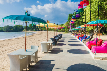 Cafe with colorful umbrellas at beach in Bali, Nusa Dua