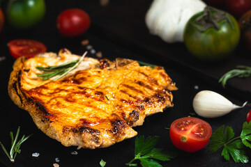 Grilled beef steak with spices on a stone background