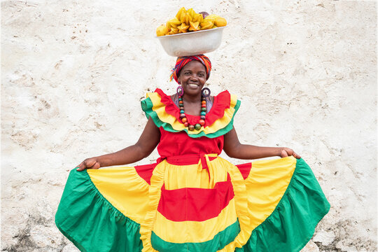 Cheerful fresh fruit street vendor aka Palenquera in the Old Town of Cartagena, Colombia. 