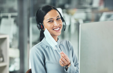 Customer service, woman call center agent with face mask and headset at her computer in her modern office. Telemarketing or networking, online communication or crm and female person for support