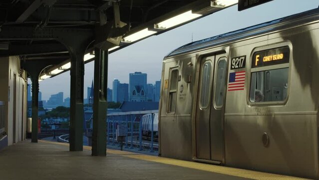 New York City F Train Leaves Elevated Brooklyn Station At Sunset Revealing Downtown Manhattan Skyline
