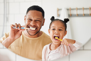 Child, father and brushing teeth in a family home bathroom for dental health and wellness in a...