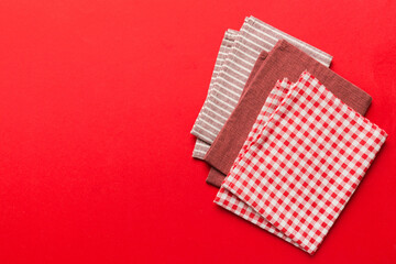 top view with red empty kitchen napkin isolated on table background. Folded cloth for mockup with copy space, Flat lay. Minimal style