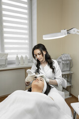 Cleansing the skin to a new level: this photo demonstrates how professional cosmetologist applies...