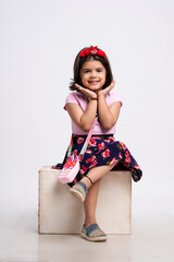 Indian little girl giving expression on white background.