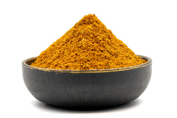 Cajun spice powder isolated on white background. Powdered dried cajun in bowl