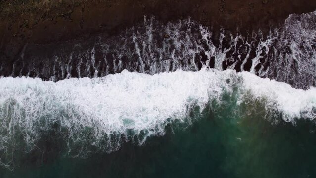 Aerial view of waves hitting coastline.
Aerial view of tropical emerald sea with coral reef in andaman island.