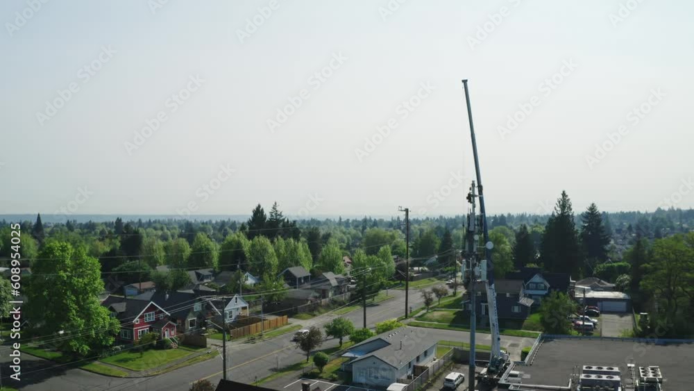 Poster workers doing maintenance work on telecom tower with mobile crane. aerial