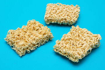 Uncooked Instant Noodles on Blue Background. Raw Pasta. Dry Asian Fast Food. Quick Lunch