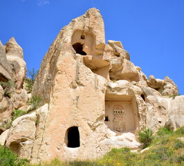 Turkiye, Goreme, positioned between the rock formations called fairy chimneys, between valleys and...