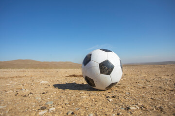 football in a lonely desert