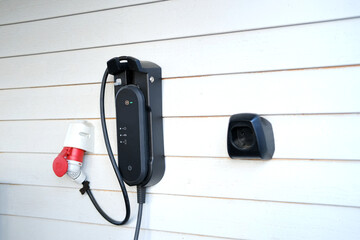 home filling station, charging station, electric car cable on garage wall, alternative energy...