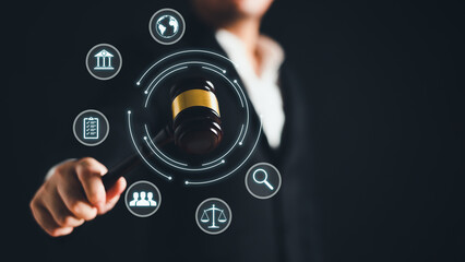 Lawyer holding gavel hammer for online internet law consultant on black background. Legal occupation and Business Consulting concept. Closeup man hand showing mallet with graphic user interface