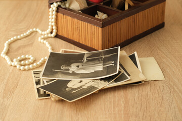 stack of old retro family sepia photos on table, vintage wooden box with dear heart memorabilia,...