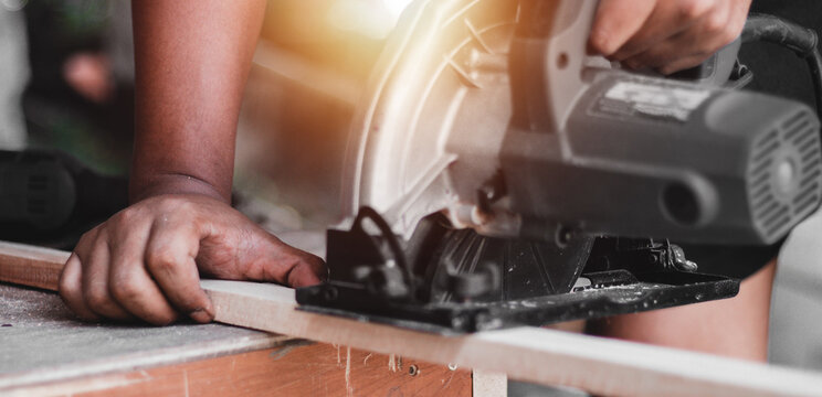 Carpenter working with equipment on wooden table