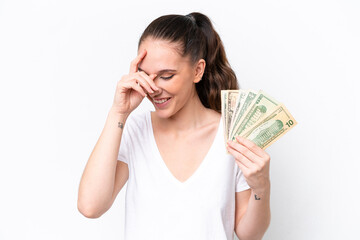 Young caucasian woman taking a lot of money isolated on white background laughing