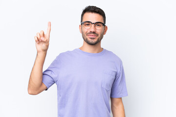 Young caucasian man isolated on white background pointing up a great idea