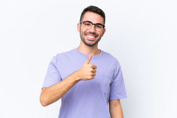 Young caucasian man isolated on white background giving a thumbs up gesture