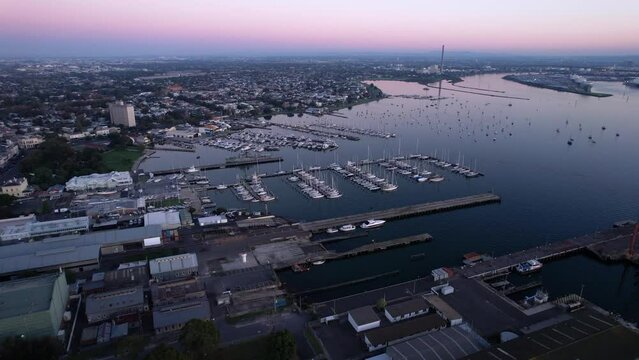 Aerial forward over harbour of Williamstown on blue hour, violet sunset sky