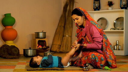 Young Indian mother massaging her newborn baby with oil - oil massage  body massage  bay care ...