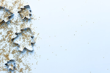Forms for Christmas cookies with glitter. Christmas flatly on blue background