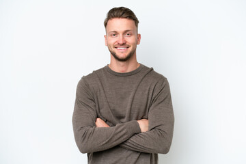 Young blonde caucasian man isolated on white background keeping the arms crossed in frontal position