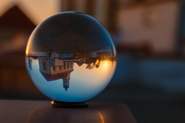 Crystal ball sunset shot with a church at Irlbach, Danube, Straubing-Bogen, Bavaria, Germany