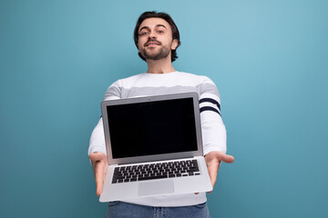 charming positive 30s man in red shirt holding laptop screen forward