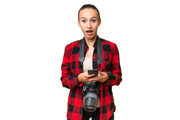 Young photographer Arab woman over isolated background surprised and sending a message