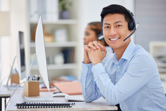 Business man, portrait and call center consultation in a office working on a computer. Smile, Asian male worker and web support advice of a contact us employee with professional communication at job