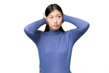 Young Asian woman over isolated chroma key background frustrated and covering ears
