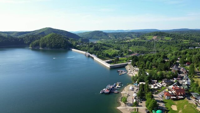 Panoramic drone view of sailboats and ships sailing on Solina lake overlooking the Gondola cable car over Solina lake and Solina dam in Polish Bieszczady Mountains, Poland.