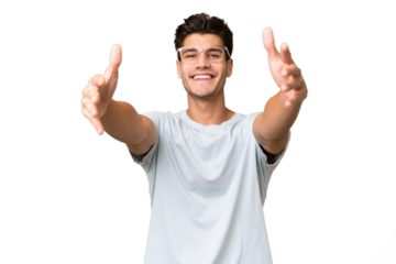 Young caucasian handsome man over isolated background presenting and inviting to come with hand