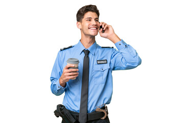 Young police man over isolated background holding coffee to take away and a mobile