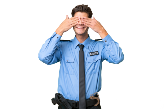 Young police man over isolated background covering eyes by hands