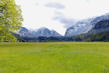 Scenic view of Haslital Valley with village of Meiringen in the background on a blue cloudy spring day. Photo taken April 27th, 2016, Meiringen, Canton Bern.
