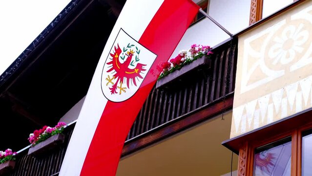 silk national flag with coat arms European state of Austria, Tyrol flutters in wind, concept of tourism, economy, politics, independence day, rights and freedoms of citizens, fair elections