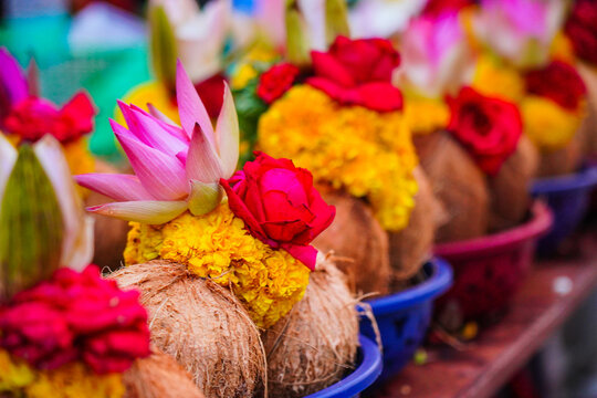 Pealed coconuts, lotus , rose and other flowers prepared for pooja, ritual worship in a temple