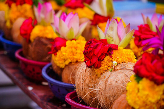Pealed coconuts, lotus , rose and other flowers prepared for pooja, ritual worship in a temple
